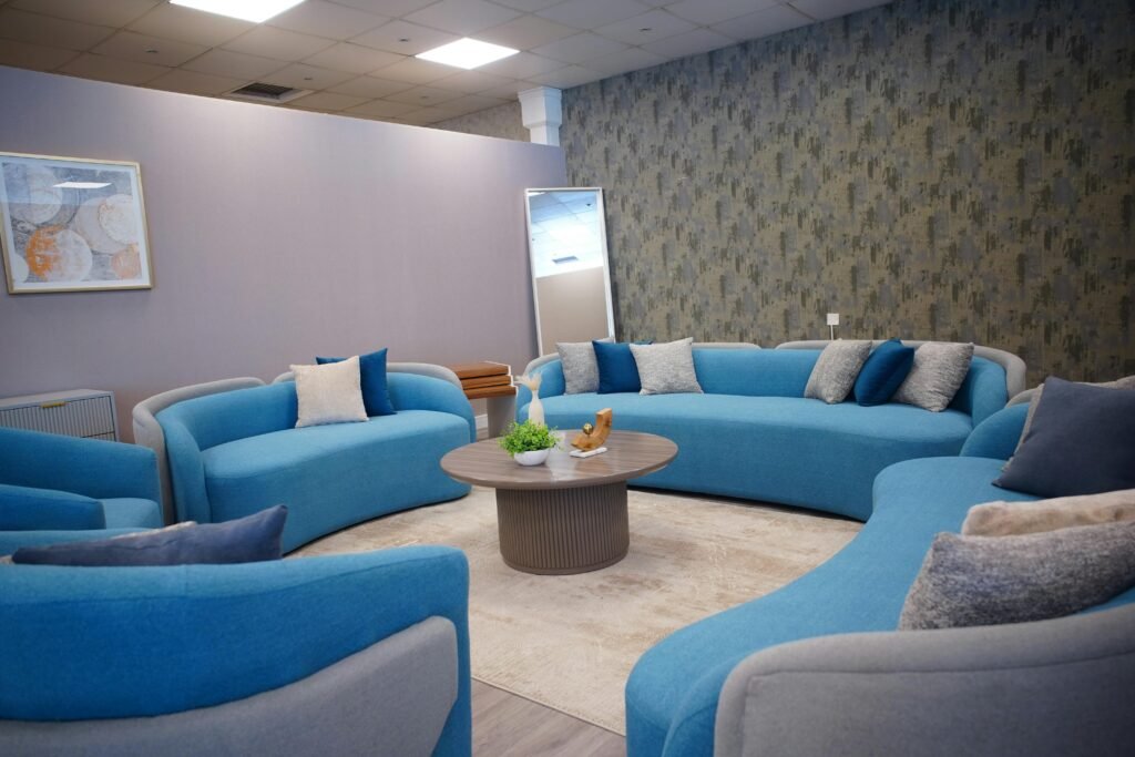 Elegant living room with contemporary blue sofas and cozy decor.